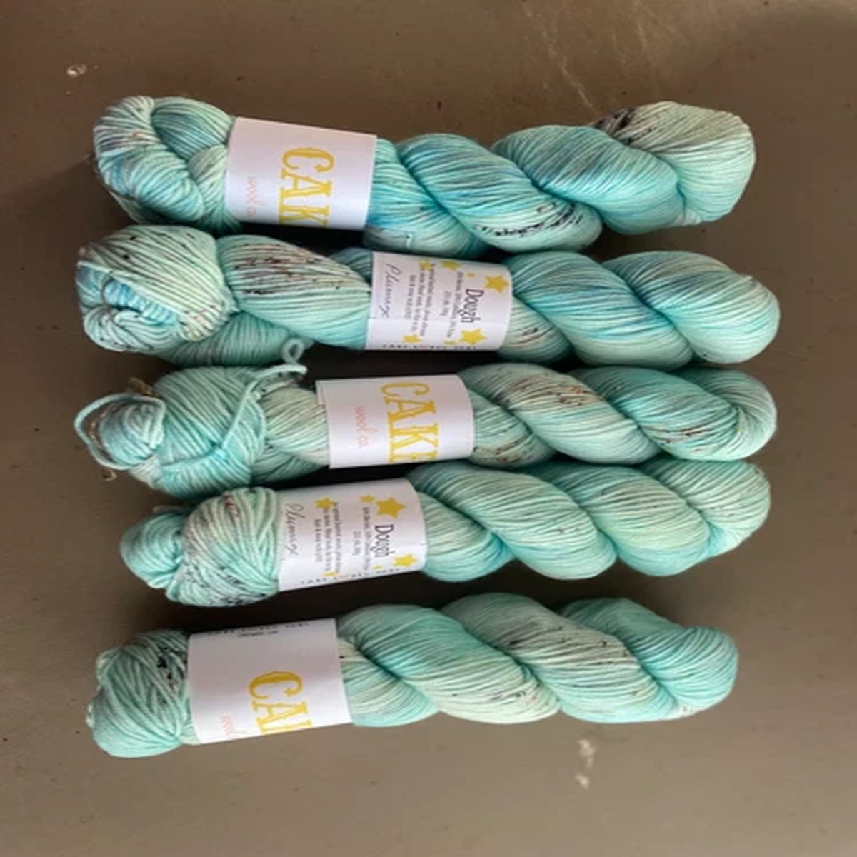 Cake Wool Company yarn, dough base Plumage colorway, 5 skeins