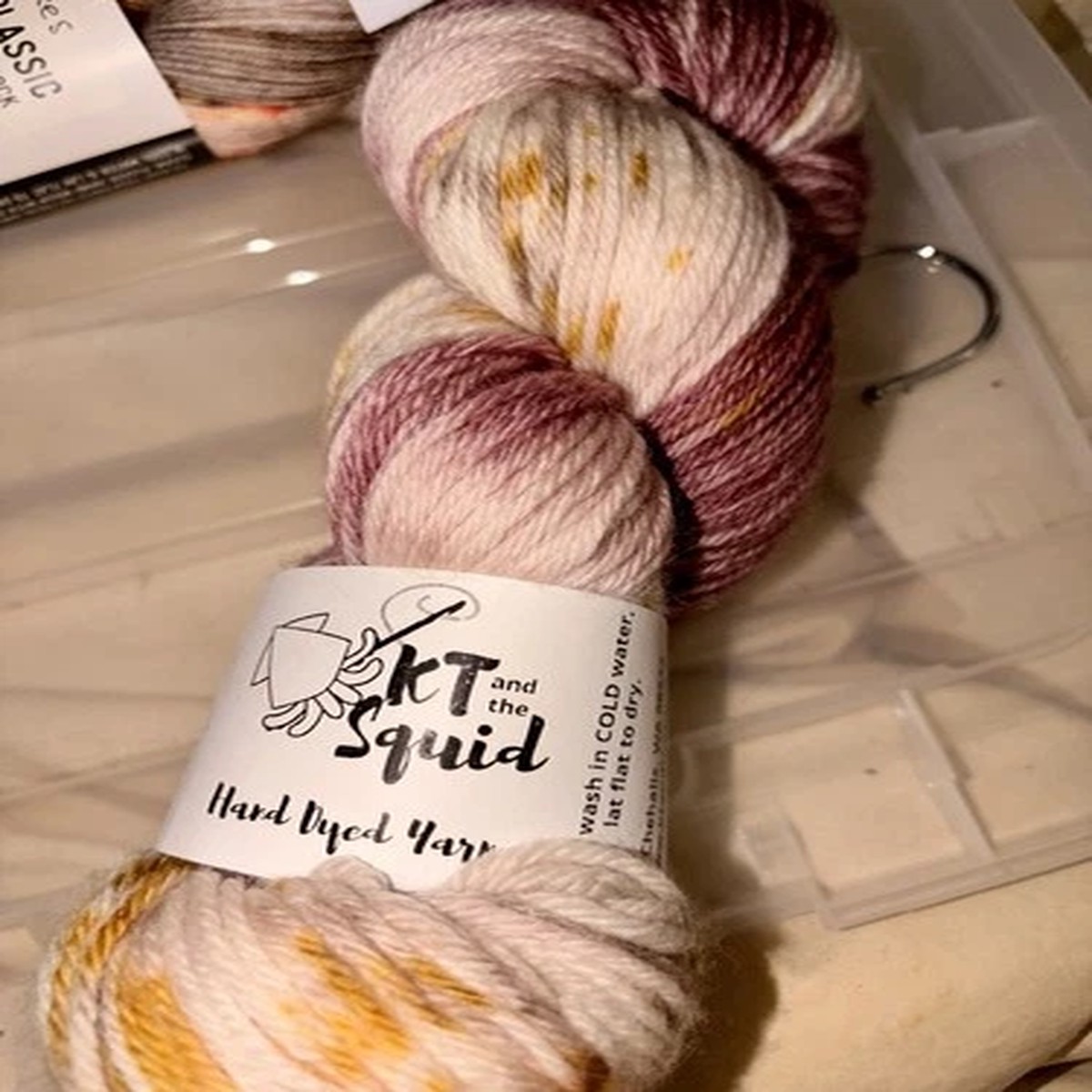 KT Squid DK Superwash Merino Color: Biscuit Splash Hand Dyed Yarn. Purple Cream
